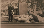 Peter P. Verigin standing by the tomb of his father, recently bombed