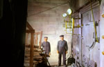 Engineers inside steam engine room