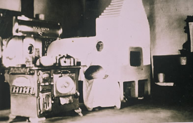 [ Woman by woodstove in typical Doukhobor communal home, Unknown, UBC Special Collections 14-19 ]