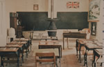 A typical Western Canadian rural school room of the 1920s.  Note the evident focus on patriotism and the attention to discipline and order.  How would Doukhobor parents have reacted to the prospect of their children spending hours every day in such a location?